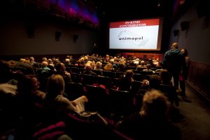 Full theater at Ann Arbor Polish Film Festival, with sponsor highlighted on presentation shown on-screen between movies.